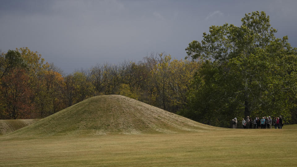 Visitors tour the Mound City Group at Hopewell Culture National Historical Park in Chillicothe, Ohio, Saturday, Oct. 14, 2023, before the Hopewell Ceremonial Earthworks UNESCO World Heritage Inscription Commemoration ceremony. A network of ancient American Indian ceremonial and burial mounds in Ohio noted for their good condition, distinct style and cultural significance, including Hopewell Culture National Historical Park, was added to the list of UNESCO World Heritage sites. (AP Photo/Carolyn Kaster)