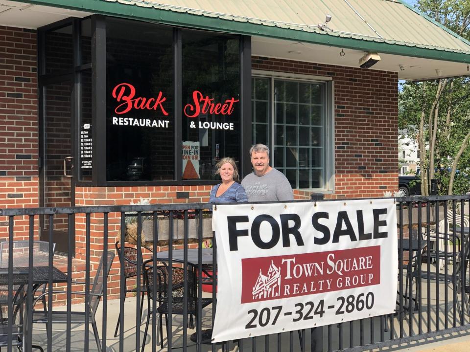 Paul Pelletier and his fiancee, Jill Brown, are seen here on July 11, 2023, in front of Back Street Sanford, the restaurant Pelletier owned and operated for five years. Pelletier is retiring and selling the popular spot on School Street in Sanford, Maine.