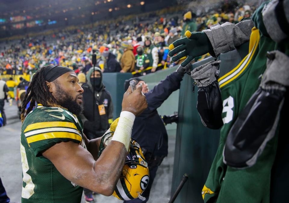 Green Bay Packers running back Aaron Jones signs autographs after a game against the Los Angeles Rams on Dec. 19 at Lambeau Field in Green Bay, Wisconsin. The Packers won the game 24-12.