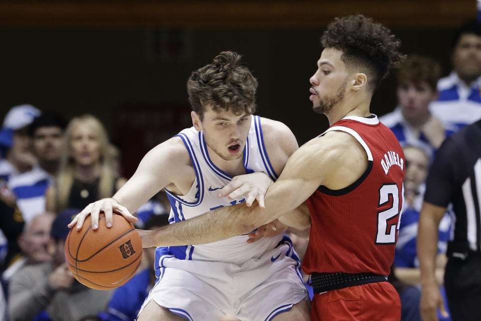 North Carolina State guard Devon Daniels, right, guards Duke forward Matthew Hurt during the first half of an NCAA college basketball game in Durham, N.C., Monday, March 2, 2020. (AP Photo/Gerry Broome)
