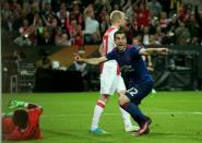 Manchester United's Henrikh Mkhitaryan (R) celebrates scoring against Ajax Amsterdam (L) during their UEFA Europa League final on May 24, 2017 at the Friends Arena in Solna outside Stockholm