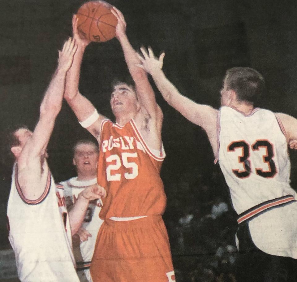 Roslyn's Tyler Lee shoots over Doland-Conde's Joe Smith and Jordan Huber during the 2001 Region 1B boys basketball tournament at Aberdeen.