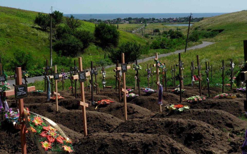 New graves at a cemetery in the Vinogradnoe district of the Donetsk region - AFP