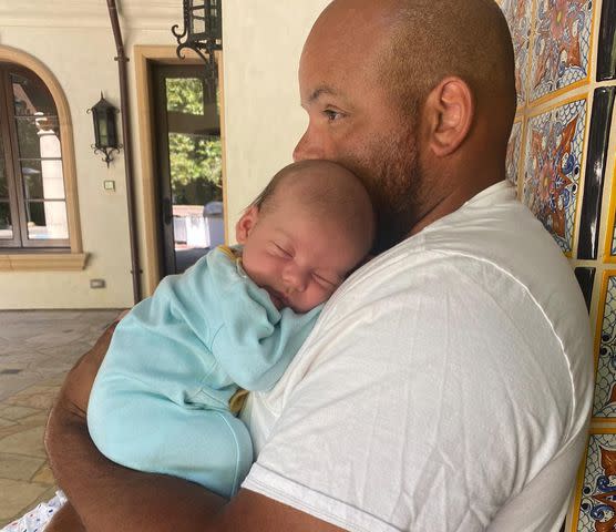 Halsey Instagram Halsey's dad Chris Frangipane holding her son Ender Ridley Aydin.
