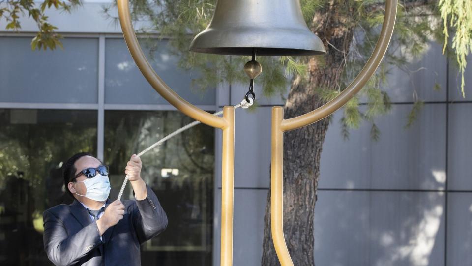 Michael Nguyen, a lecturer in the California State University, San Bernardino teacher education and foundation program, rings the bell at the Peace Garden during a Day of Remembrance to honor those killed during the terrorist attack on Dec. 2, 2015 in San Bernardino.