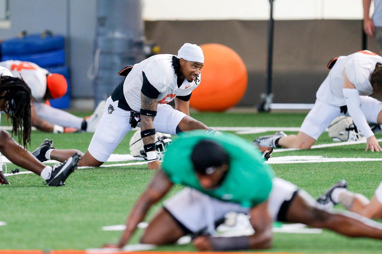 Lyrik Rawls (6) stretches out during an Oklahoma State football practice in Stillwater, Okla., on Tuesday, April 23, 2024.