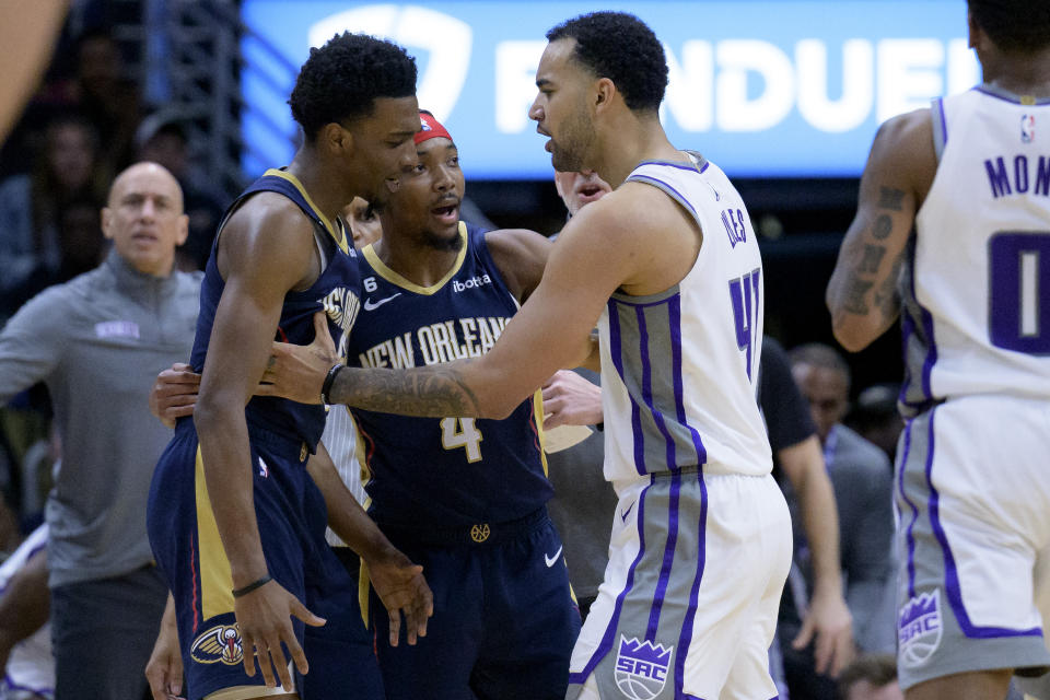 New Orleans Pelicans forward Herbert Jones, left, and Sacramento Kings forward Trey Lyles (41) exchange words in the first half of an NBA basketball game with New Orleans Pelicans guard Devonte' Graham trying to keep them apart in New Orleans, Sunday, Feb. 5, 2023. (AP Photo/Matthew Hinton)