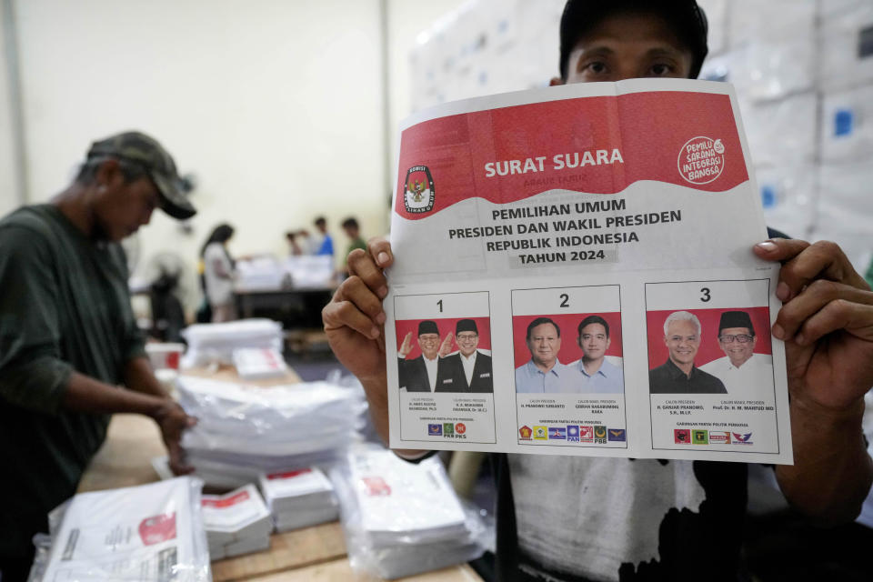 A worker shows ballot prepared for the upcoming presidential election at an election logistics distribution point in South Tangerang, Indonesia, Wednesday, Jan. 10, 2024. Indonesia, the world's third-largest democracy, will open its polls on Wednesday to nearly 205 million eligible voters in presidential and legislative elections, the fifth since Southeast Asia's largest economy began democratic reforms in 1998. (AP Photo/Tatan Syuflana)