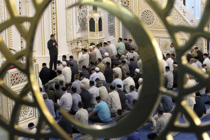 People pray in a mosque celebration the Eid al-Adha, or the "Festival of Sacrifice," in Shali, about 40 kilometers (25 miles) south-east of Grozny, the capital of Chechen Republic, Russia, Saturday, July 9, 2022. Around the world, Muslims will mark the end of the pilgrimage with Eid al-Adha. The holiday commemorates the prophet Ibrahim's willingness to sacrifice his son Ismail at God's request. Muslims traditionally slaughter sheep and cattle, dividing the meat among the needy, friends and relatives. (AP Photo/Musa Sadulayev)