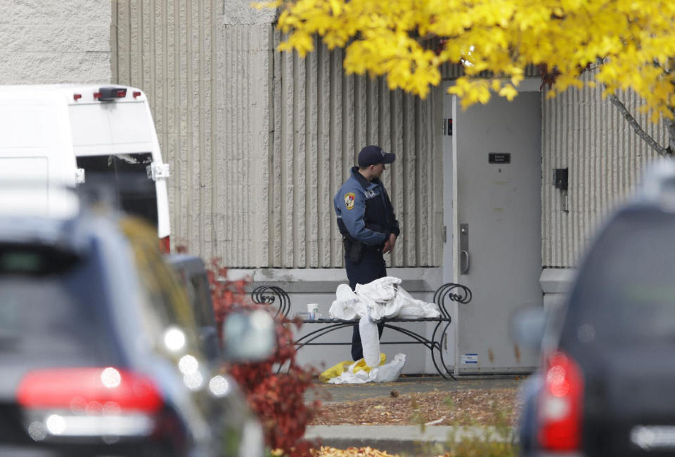 <p>A Burlington Police officer stands guard at a side entrance to the Macy’s department store at the Cascade Mall, Saturday, Sept. 24, 2016, in Burlington, Wash. Friday night, a man with a rifle opened fire in a Macyís Department Store at the mall, killing several people. (AP Photo/Ted S. Warren) </p>