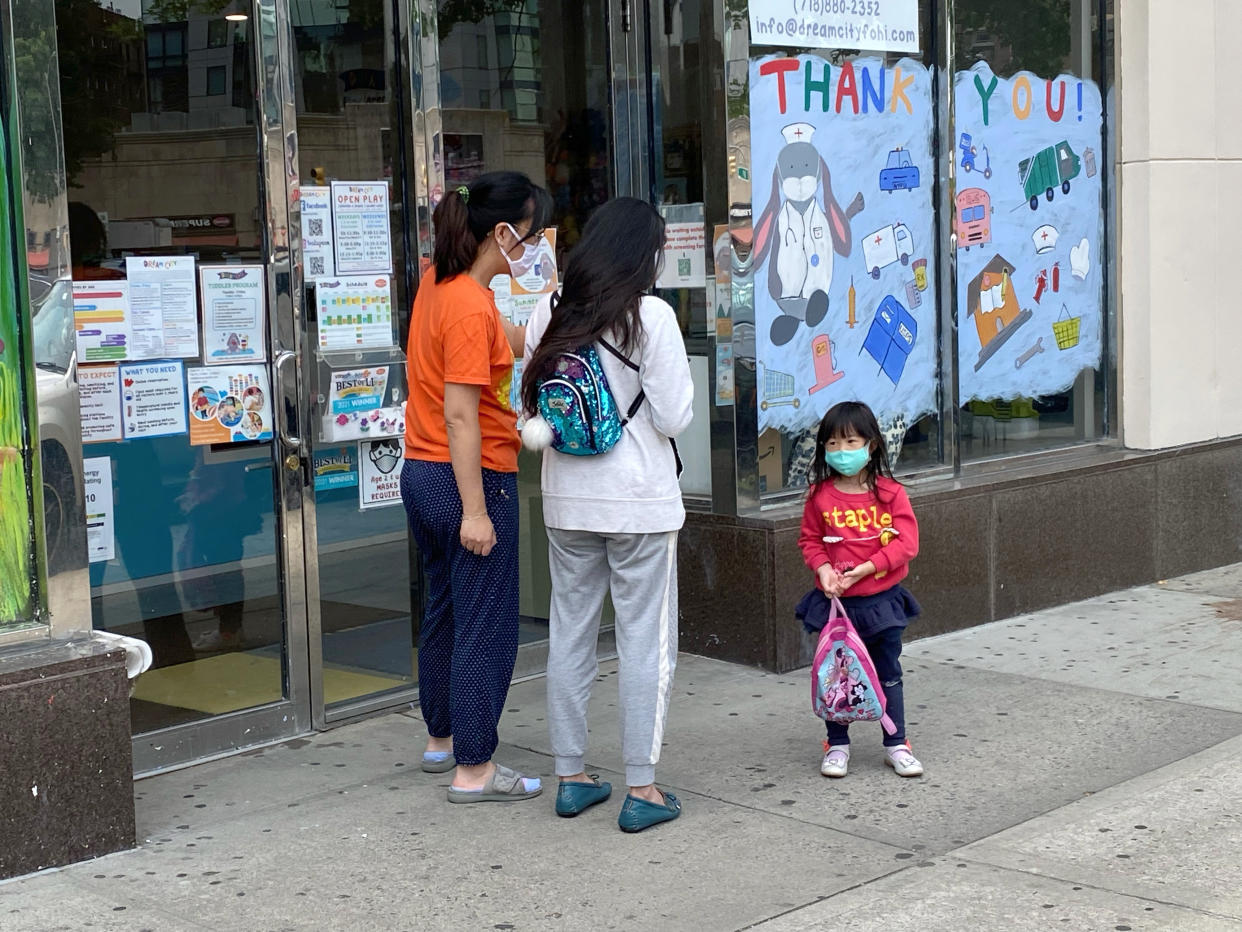 Mothers and a child outside a day care center in Queens, New York. 