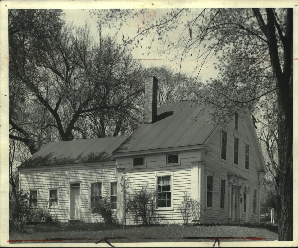 The back addition and chimney is visible in this 1948 photo of the Lowell Damon House.