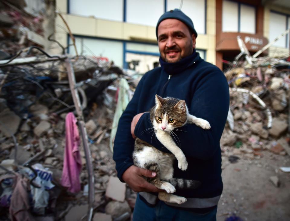 A man holds his cat rescued from a collapsed building in Kahramanmaras, southern Turkey, Saturday, Feb. 11, 2023. Rescuers in Turkey miraculously continued to pull earthquake survivors out of the rubble on Saturday. The unlikely rescues, came five days after Monday's 7.8-magnitude quake.
