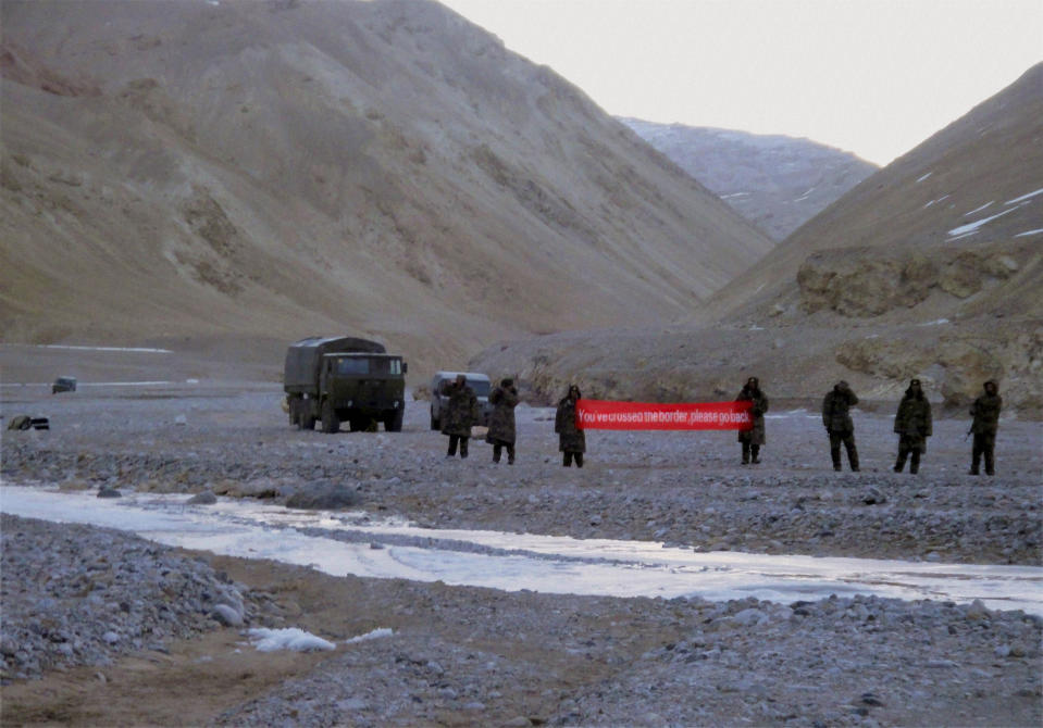 FILE- Chinese troops hold a banner which reads: "You've crossed the border, please go back," in Ladakh, India, May 5, 2013. Since a deadly border clash between Indian and Chinese soldiers in the Ladakh region in the mid-2020, policy makers in New Delhi have been increasingly turning their focus to Beijing, in a significant shift in India's foreign policy as the nation celebrates 75 years of independence. (AP Photo, File)