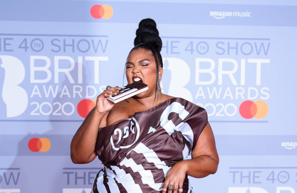 Lizzo strutted down the red carpet at the 2020 BRIT Awards in a Moschino gown inspired by a chocolate bar. The look included an unusual accessory; a chocolate bar shaped clutch.