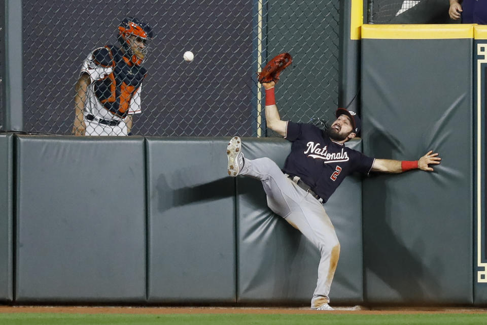 Washington Nationals right fielder Adam Eaton can't get a glove on a RBI-double by Houston Astros' George Springer during the eighth inning of Game 1 of the baseball World Series Tuesday, Oct. 22, 2019, in Houston. (AP Photo/Matt Slocum)