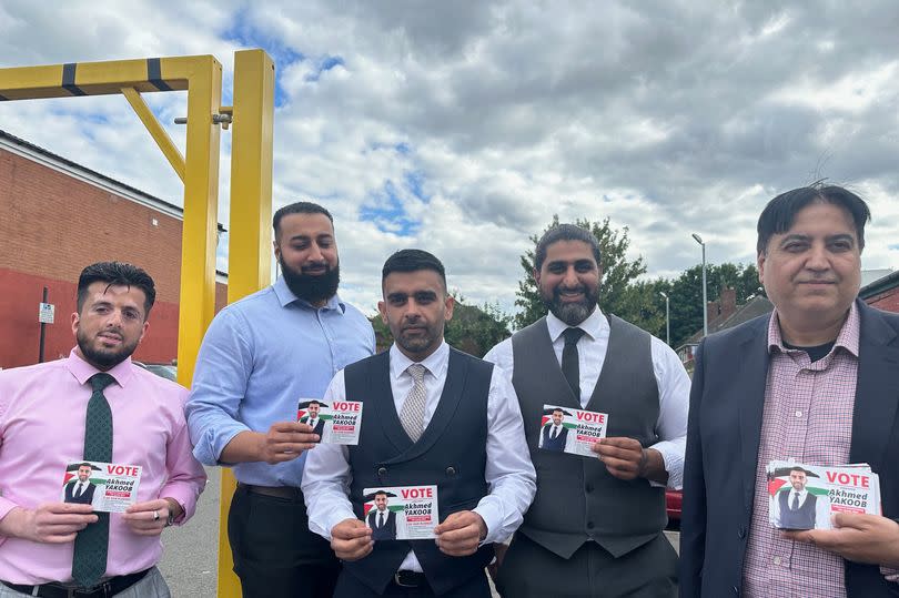 Akhmed Yakoob, centre, and his campaign manager Zulfigar Khan, right, with local solicitors who back his campaign.