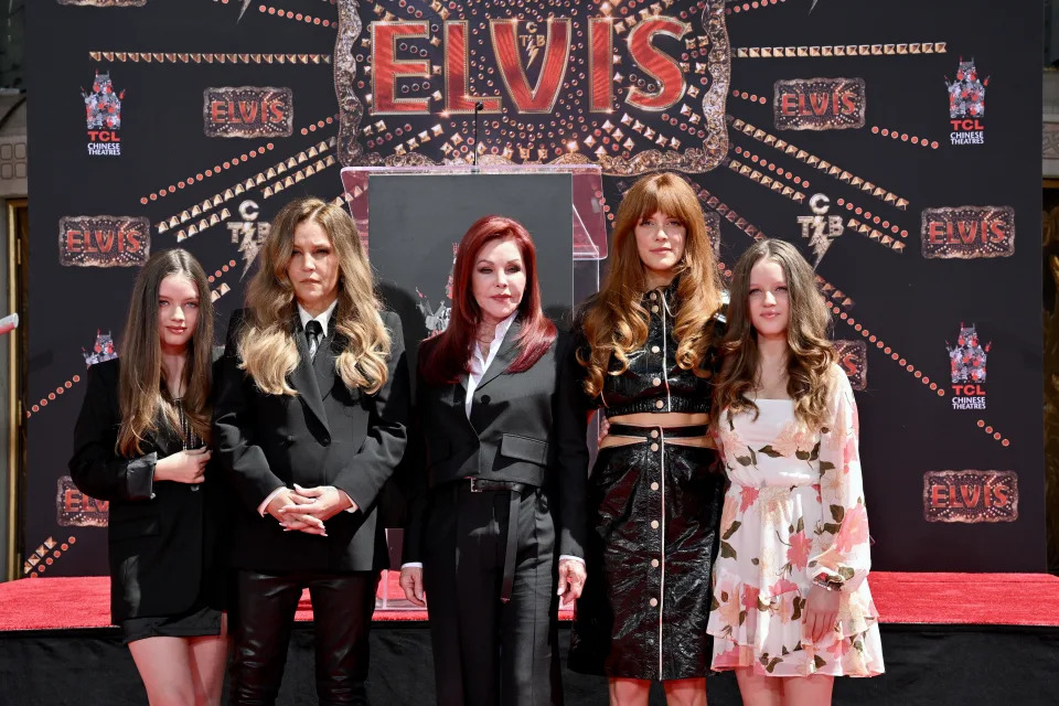 Riley, Harper Lockwood, Lisa Marie, Priscilla Presley and Finley Lockwood stand in front of sign that reads: Elvis