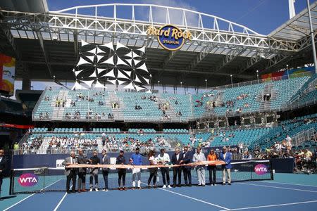 Mar 20, 2019; Miami Gardens, FL, USA; (ML-MR) Naomi Osaka of Japan, Novak Djokovic of Serbia, Serena Williams of the United States, Roger Federer of Switzerland, and Miami Dolphins and Hard Rock Stadium owner Steven Ross participate in a ribbon cutting ceremony on new stadium court at Hard Rock Stadium prior to play in the first round of the Miami Open at Miami Open Tennis Complex. Geoff Burke