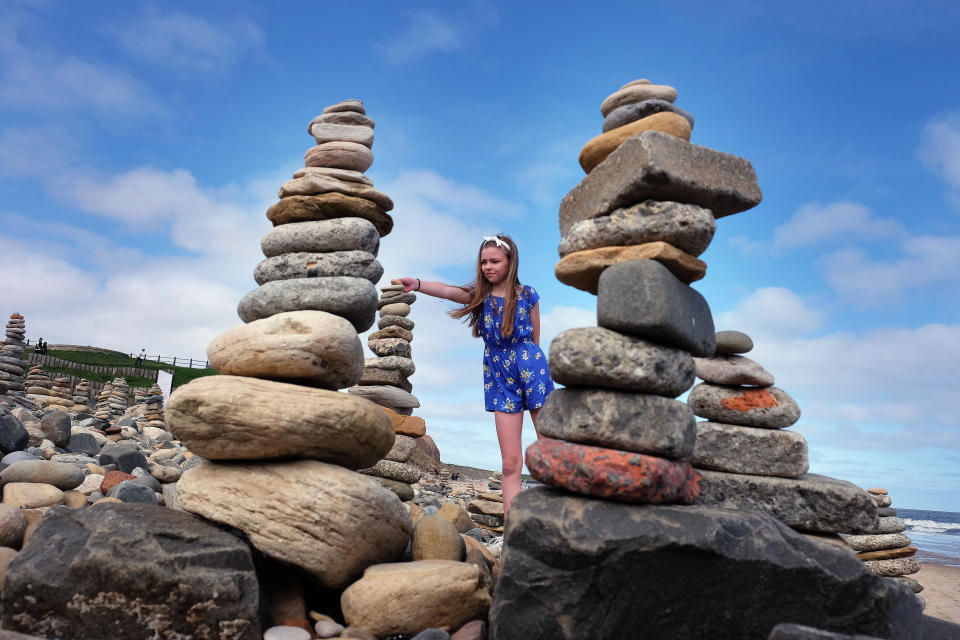 Pebble sculptures in Whitley Bay beach on the North East coast, while people are taking their daily lockdown exercise they have kept adding pebble sculptures transforming the beach as the UK continues in lockdown to help curb the spread of the coronavirus. PA Photo Owen Humphreys .