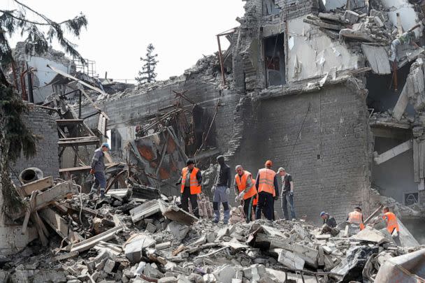 FILE PHOTO: Emergency management specialists and volunteers remove debris of the Donetsk Academic Regional Drama Theater, destroyed in the course of Russia's war on Ukraine, in port city of Mariupol, southeastern Ukraine, April 25, 2022. (Alexander Ermochenko/Reuters, File)