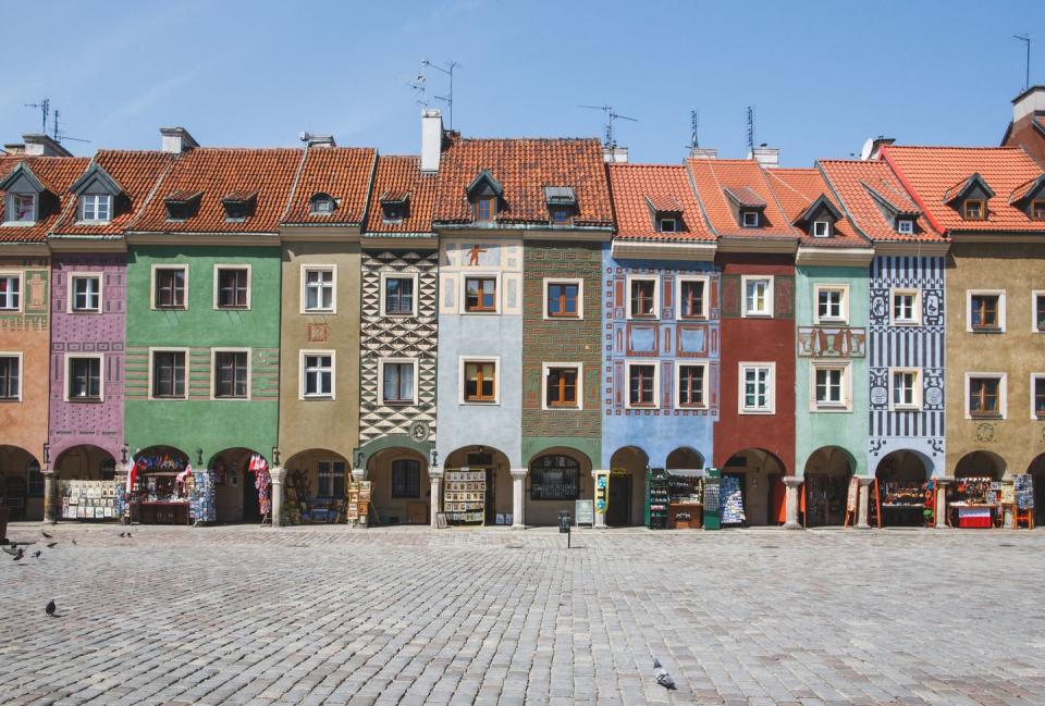 <p>Narrow row houses are broken up with color on the streets of Poznań, Poland.</p>