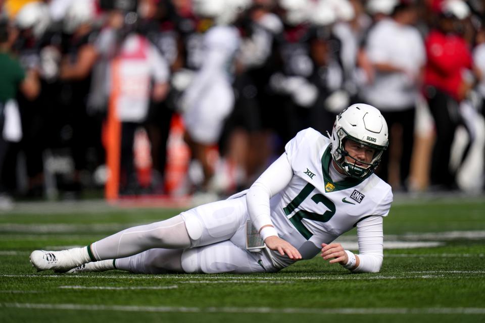 Baylor Bears quarterback Blake Shapen (12) is slow to get up after a quarterback hit in the first quarter during a college football game between the Baylor Bears and the Cincinnati Bearcats, Saturday, Oct. 21, 2023, at Nippert Stadium in Cincinnati.