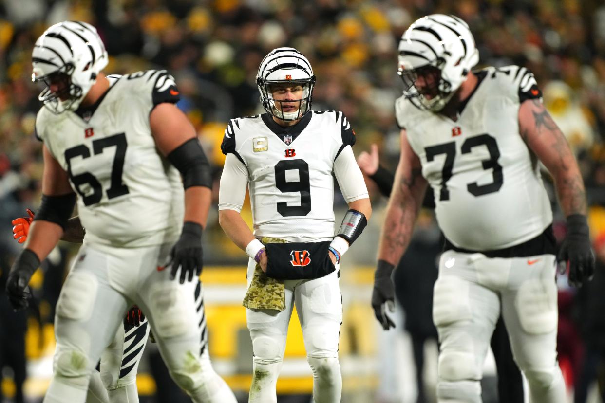 Cincinnati Bengals quarterback Joe Burrow (9) lines up for a snap as Cincinnati Bengals offensive tackle Cordell Volson (67) and Cincinnati Bengals offensive tackle Jonah Williams (73) get set in the second quarter during a Week 11 NFL game, Sunday, Nov. 20, 2022, at Acrisure Stadium in Pittsburgh, Pa.