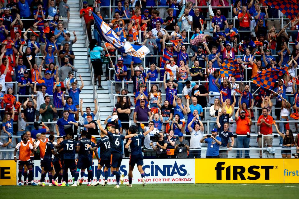 FC Cincinnati team surround FC Cincinnati midfielder Luciano Acosta (11) after scoring a goal in the first half of the MLS soccer game between FC Cincinnati and Columbus Crew on Friday, July 9, 2021, at TQL Stadium in Cincinnati. 