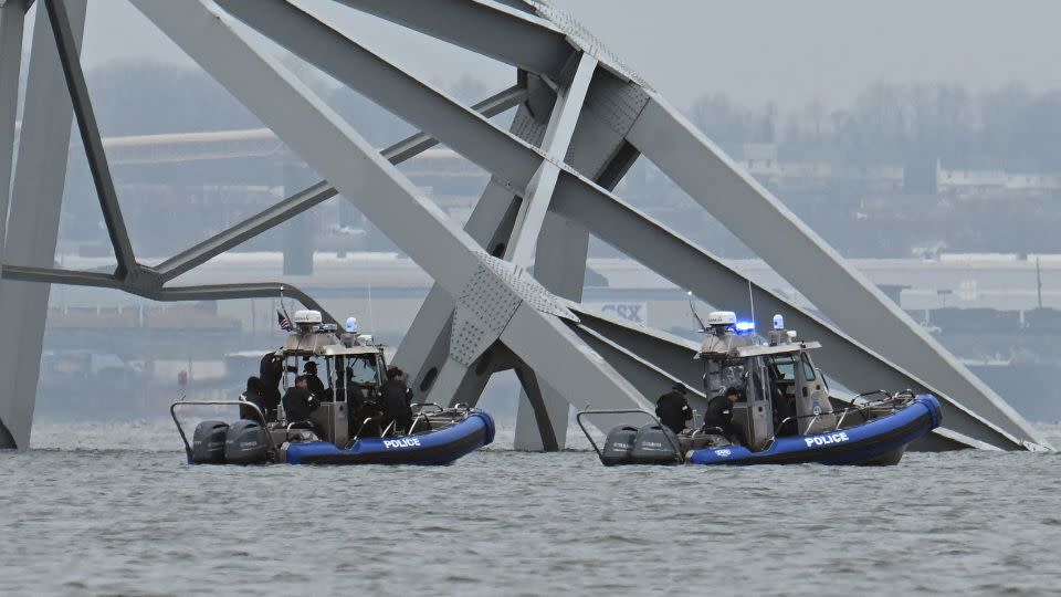 Police recovery crews work near the collapsed Francis Scott Key Bridge in Baltimore on Tuesday. - Jim Watson/AFP/Getty Images