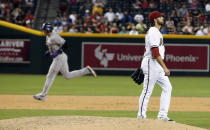 Arizona Diamondbacks' Mike Bolsinger, right, looks away as Colorado Rockies' Troy Tulowitzki (2) rounds the bases after hitting a two-run home run during the sixth inning of a baseball game on Tuesday, April 29, 2014, in Phoenix. (AP Photo/Ross D. Franklin)