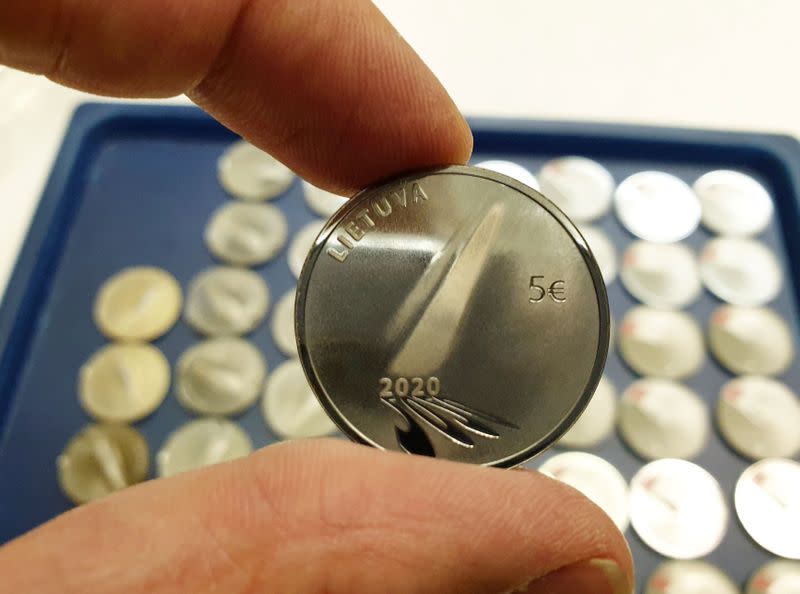 A man shows 5 Euros nominal silver coins, minted to mark the coronavirus disease (COVID-19) outbreak in Vilnius