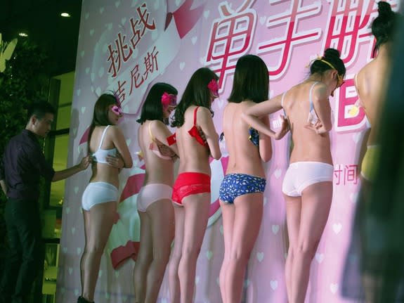 Chinese woman removes her bra in public at a luxury appraisal