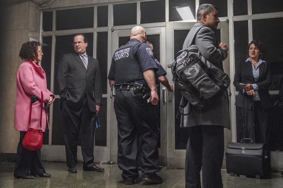 Defense attorney Susan Necheles, far left, and prosecutor Susan Hoffinger, far right, wait outside courtroom as jury deliberates Trump Organization tax fraud case Monday Dec. 5, 2022, in New York. (AP Photo/Bebeto Matthews)