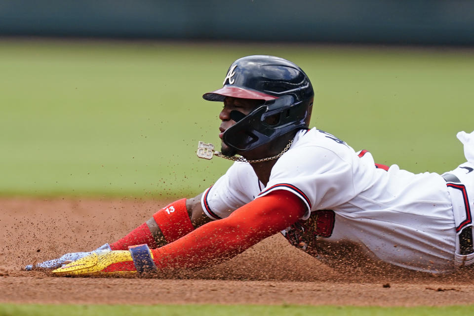 Atlanta Braves' Ronald Acuna Jr. (13) steals second base in the third inning of a baseball game against the New York Mets, Wednesday, July 13, 2022, in Atlanta. (AP Photo/John Bazemore)