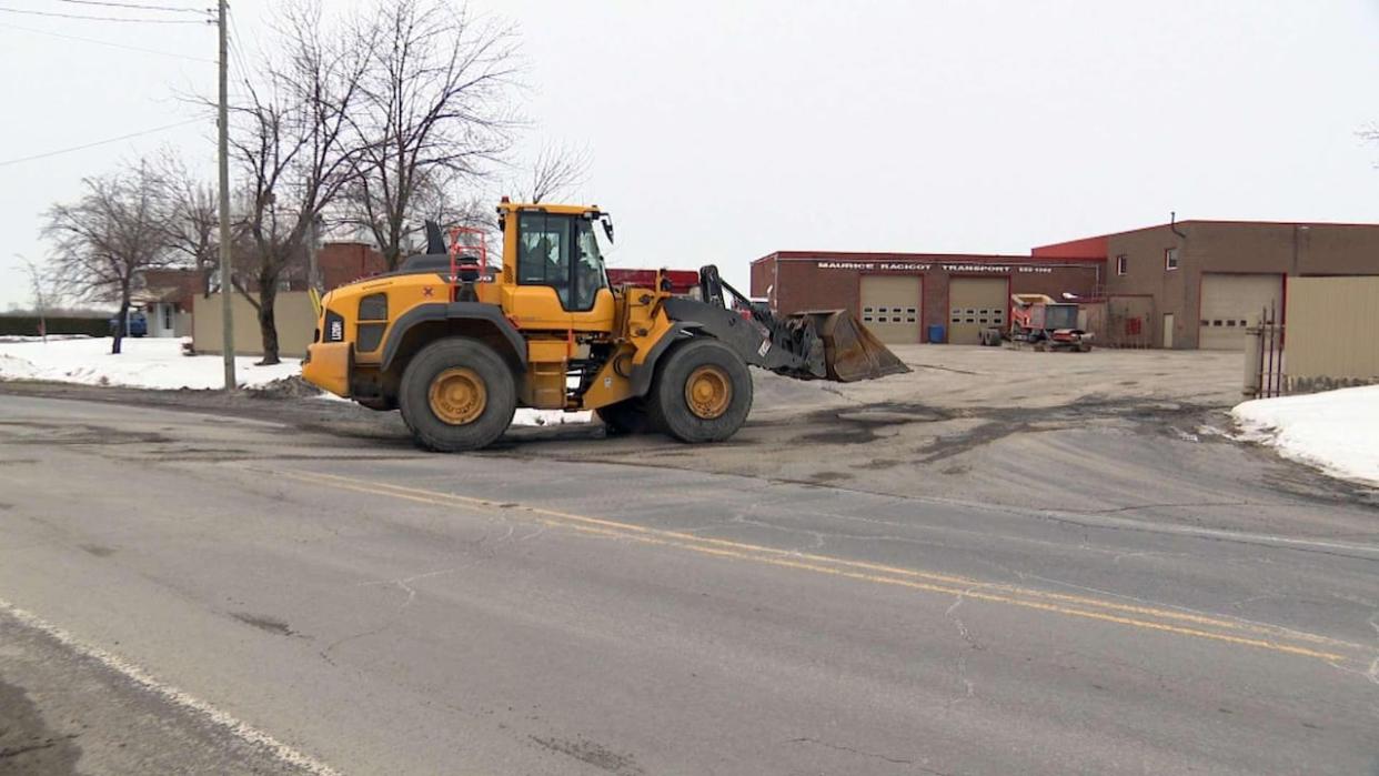 The regulation requires owners of industrial lots pay $1 per square metre of asphalt, and commercial building owners pay $1.75. (CBC - image credit)