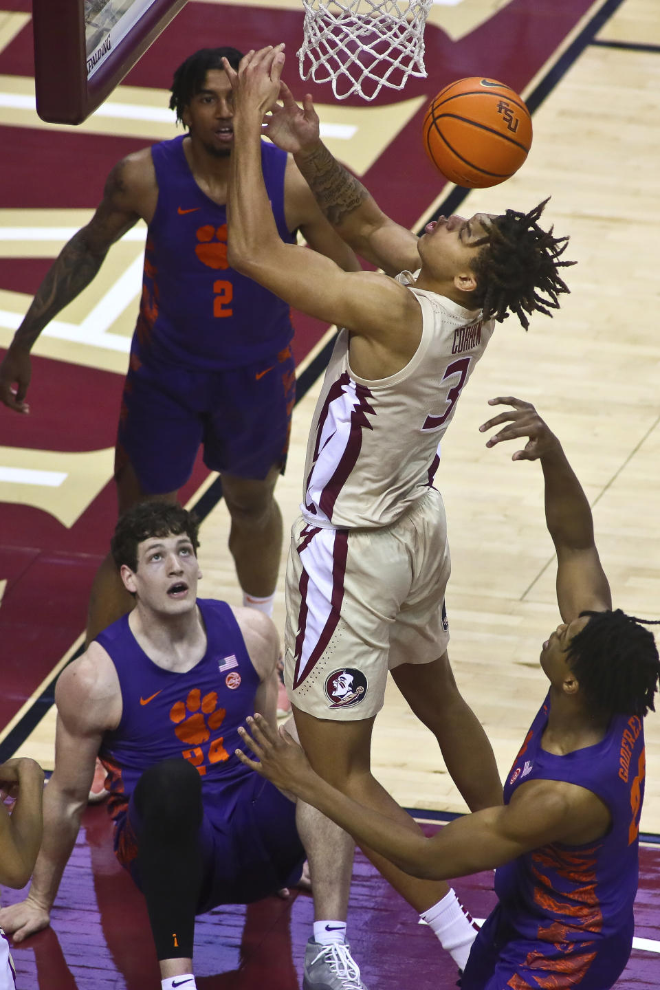 Florida State forward Cameron Corhen (3) loses the ball as he is surrounded by Clemson defenders in the first half of an NCAA college basketball game in Tallahassee, Fla., Saturday, Jan. 28, 2023. (AP Photo/Phil Sears)