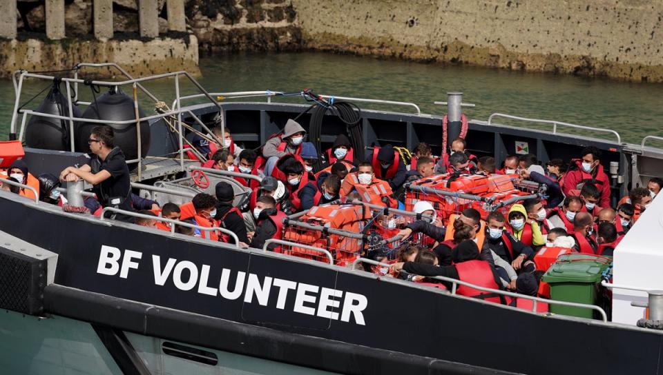 A group of people, thought to be migrants, are taken ashore at Dover on board a Border Force vessel on Sunday (PA Wire)