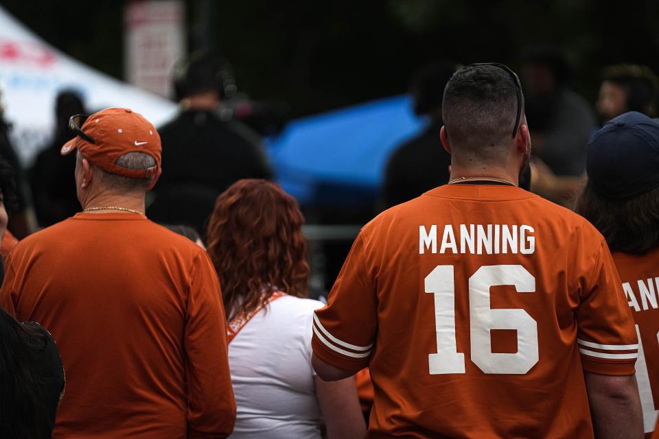 A Texas fan wears an Arch Manning jersey for the Nov. 4 game against Kansas State at Royal-Memorial Stadium. The focus on Manning, the nephew of former NFL quarterbacks Peyton and Eli Manning and the grandson of New Orleans Saints legend Archie Manning, has been constant since the day he committed to the Longhorns.