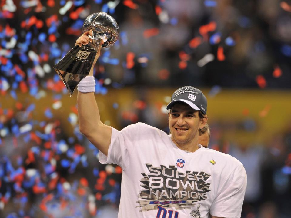 Eli Manning lifts the Lombardi Trophy after winning Super Bowl XLVI.