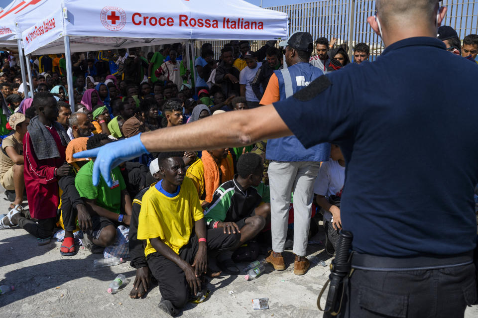 FILE - Migrants wait to be transferred from Lampedusa Island, Italy, Sept. 15, 2023. Albania has agreed to host two migrant processing centers on its territory that will be run by Italy under a deal that worries human rights activists. The European Union, however, sees it as a possible future template. (AP Photo/Valeria Ferraro, File)