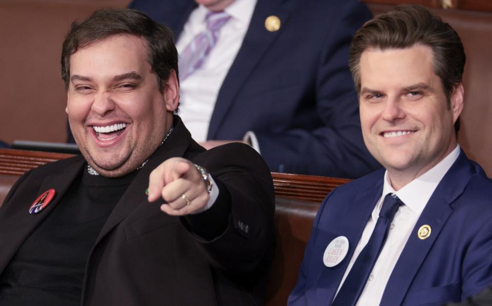 Former New York Republican representative George Santos sits with Florida Representative Matt Gaetz