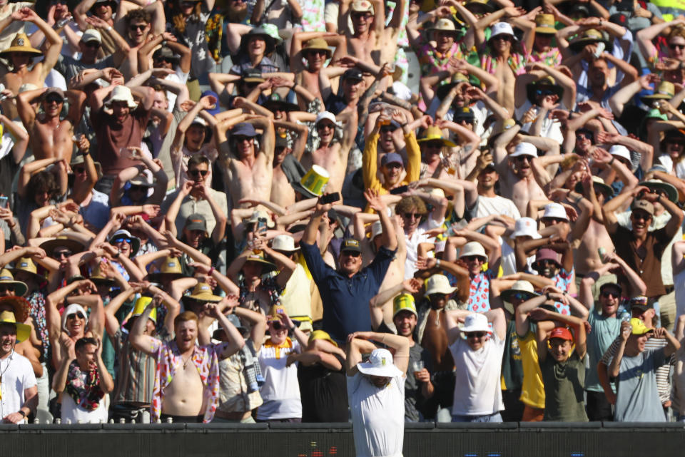 South Africa's Anrich Nortje stretches as spectators react during the second cricket test between South Africa and Australia at the Melbourne Cricket Ground, Australia, Tuesday, Dec. 27, 2022. (AP Photo/Asanka Brendon Ratnayake)