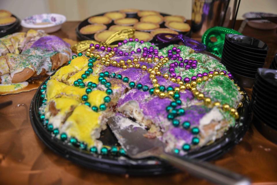 King cake is decorated in purple, green and gold.