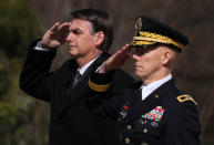 Brazil's President Jair Bolsonaro salutes during ceremonies as he lays a wreath at the Tomb of the Unknown Soldier at Arlington National Cemetery during his visit to Washington in Arlington, VA, U.S., March 19, 2019. REUTERS/Jonathan Ernst