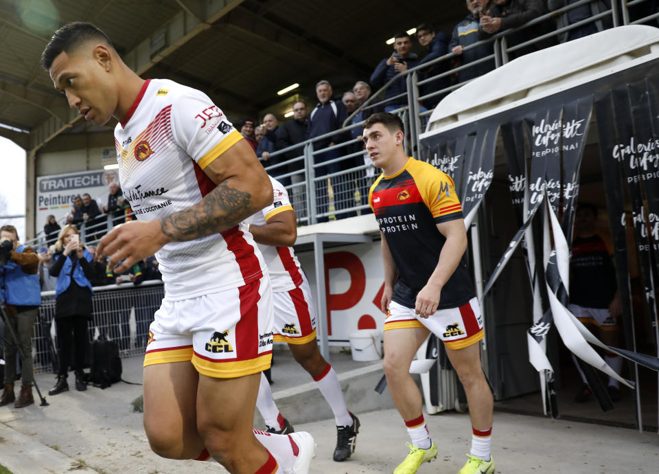 Catalans Dragons Israel Folau, left, walks out with teammates ahead of the Super League rugby match between Catalans Dragons and Castleford Tigers at Stade Gilbert Brutus in Perpignan, France, Saturday, Feb. 15, 2020. (AP Photo/Joan Monfort)