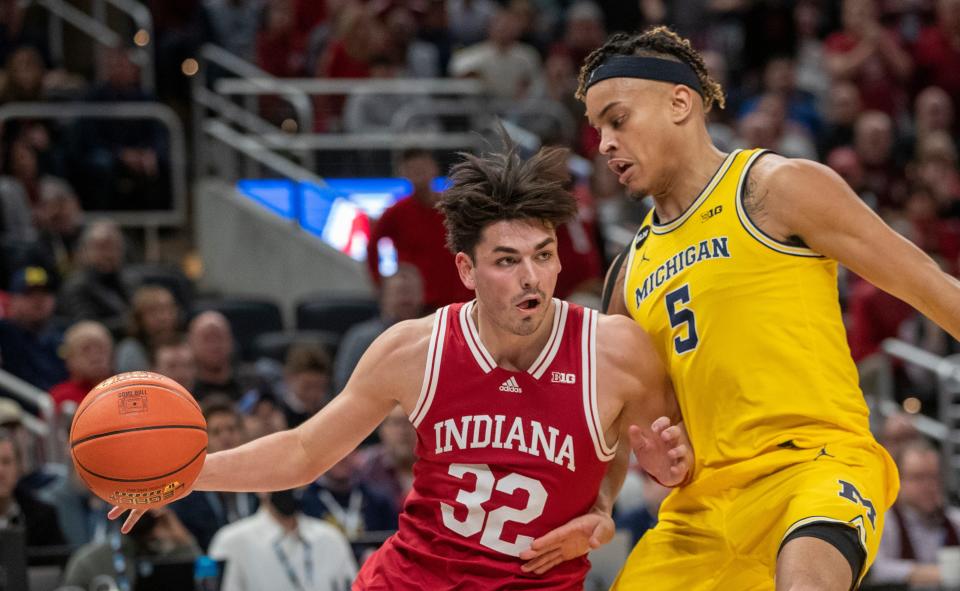 Indiana Hoosiers guard Trey Galloway (32) is defended by Michigan Wolverines forward Terrance Williams II (5), Thursday, March 10, 2022, during Big Ten tournament men’s action from Indianapolis’ Gainbridge Fieldhouse. Indiana won 74-69. 