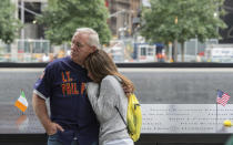 FILE - In this Sept. 11, 2015, file photo, victims' family members look on during a ceremony at the World Trade Center site in New York. The coronavirus pandemic has reshaped how the U.S. is observing the anniversary of 9/11. The terror attacks' 19th anniversary will be marked Friday, Sept. 11, 2020, by dueling ceremonies at the Sept. 11 memorial plaza and a corner nearby in New York. (AP Photo/Bryan R. Smith, File)