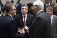 Attorney Alexander C. Dale, center, talks with fellow attorneys who represent Mark Harris during a recess in the hearing on Mark E. Harris v. NC State Board of Elections on Tuesday, Jan. 22, 2019, in Superior Court in Raleigh, N.C. A North Carolina judge is considering a demand to order the victory of the Republican in the country's last undecided congressional race despite an investigation into whether his lead was boosted by illegal vote-collection tactics. (Robert Willett/The News & Observer via AP, Pool)