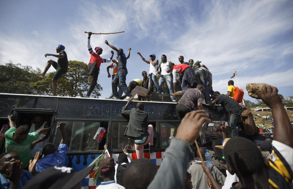 <p>Supporters of opposition leader Raila Odinga arrive by bus, as they gather in advance of a mock “swearing-in” ceremony of Odinga at Uhuru Park in downtown Nairobi, Kenya Tuesday, Jan. 30, 2018. (Photo: Ben Curtis/AP) </p>